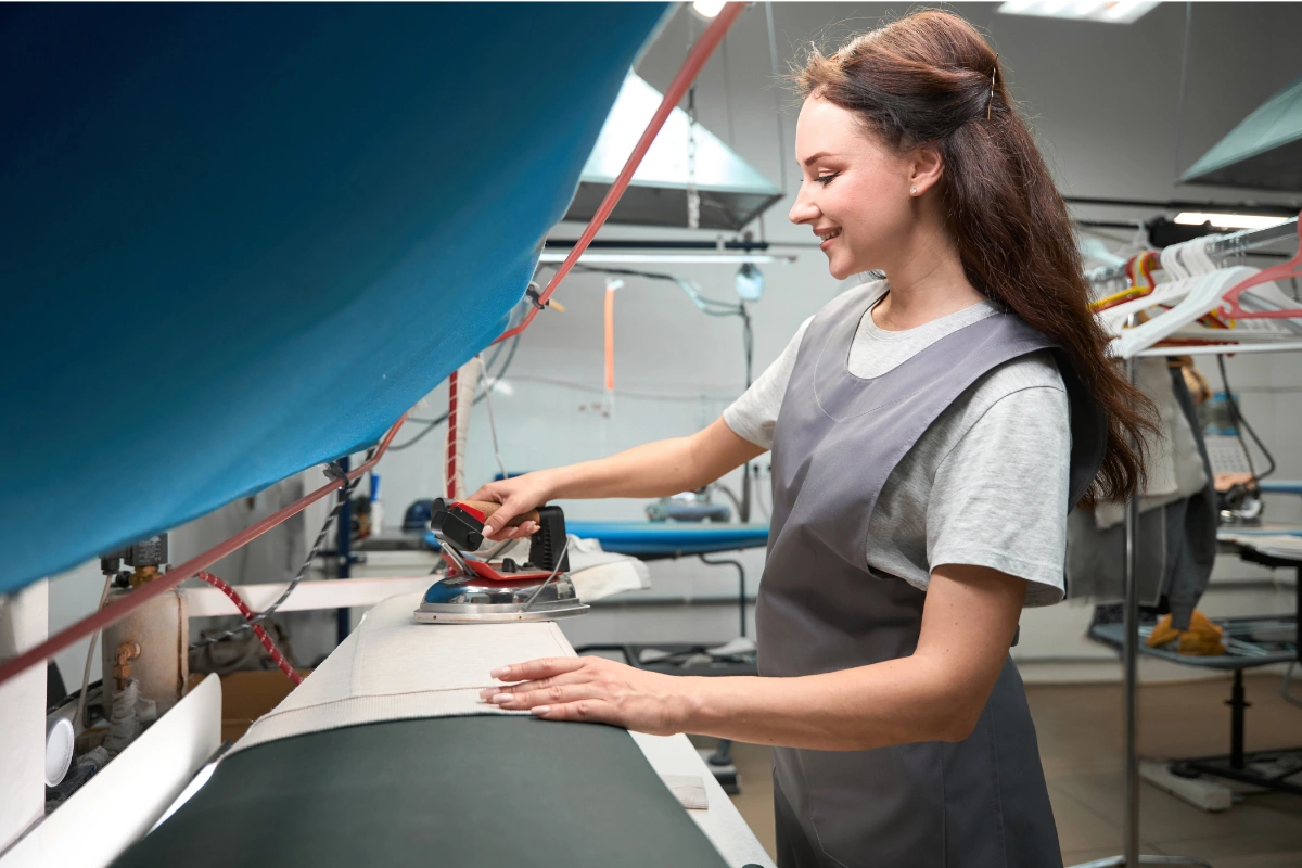A woman ironing clothes, How Often Should You Dry Clean?