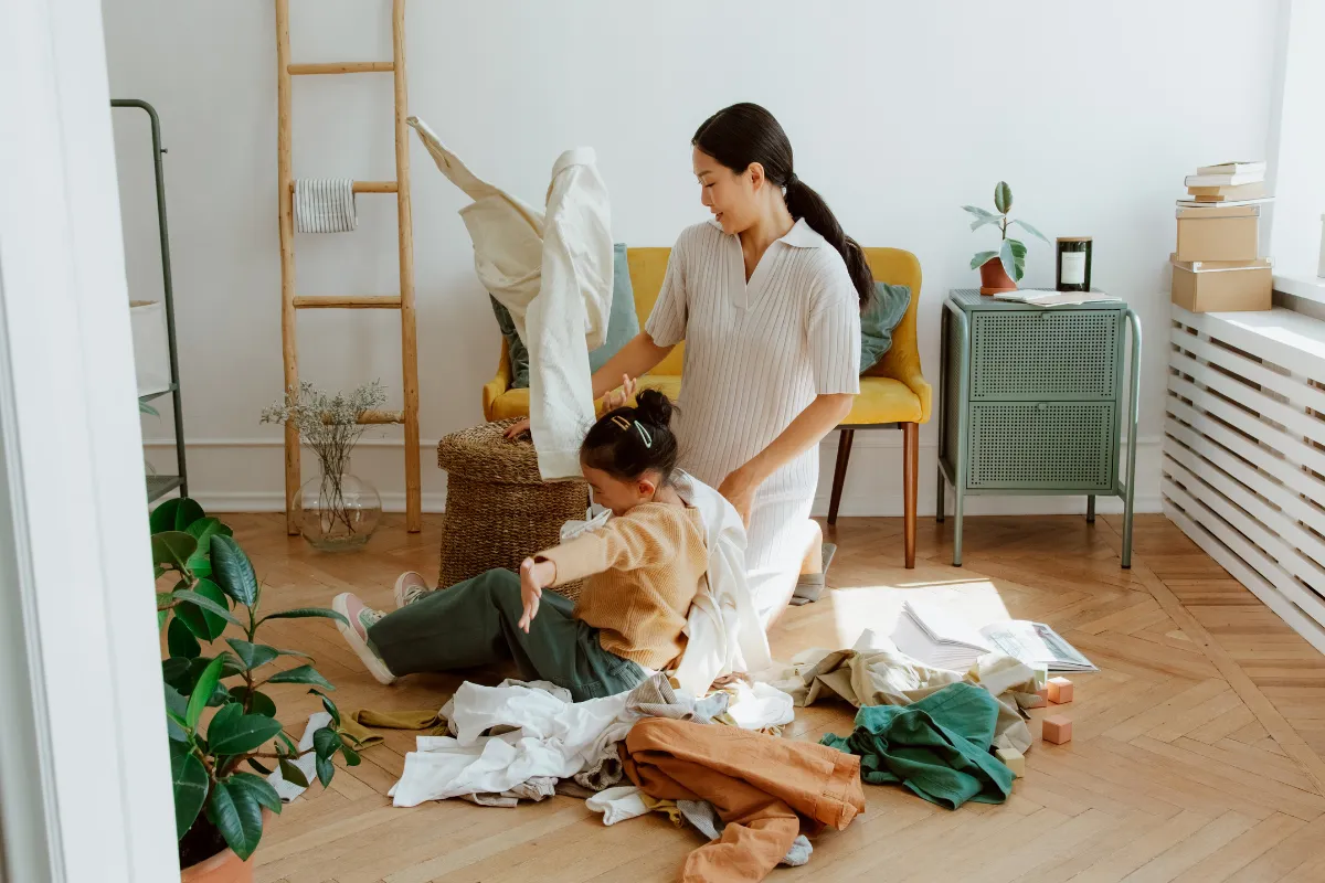 Parent and child folding laundry, how to handle endless kids’ laundry as a parent