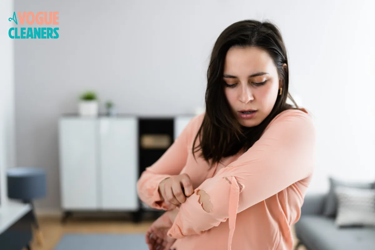 Tailor repairing a torn or damaged garment