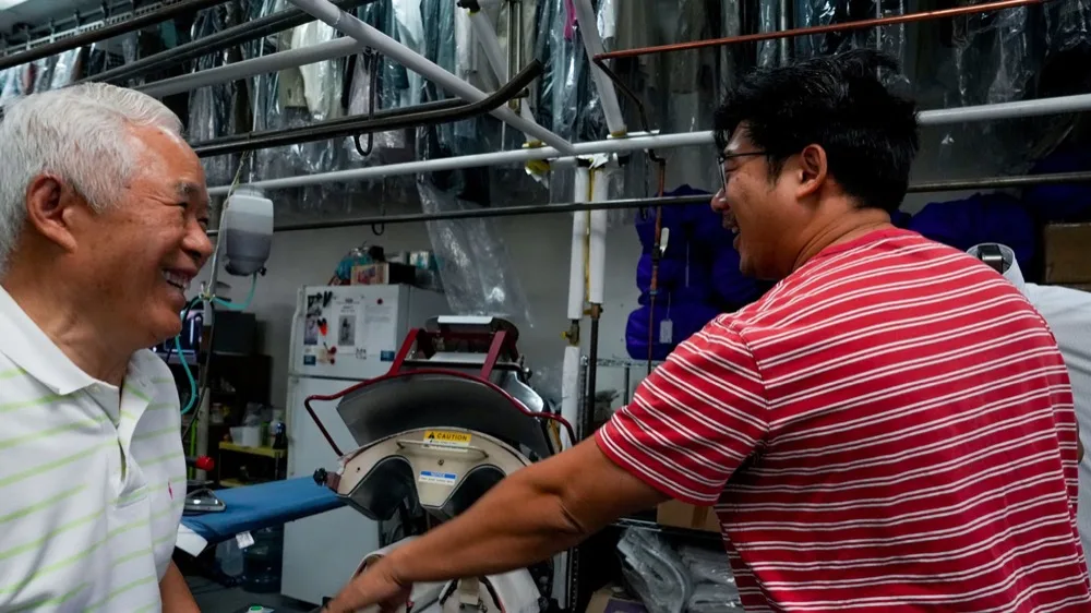 Ha Wan Ku and his son Enoch Ku working together at Vogue Cleaners.