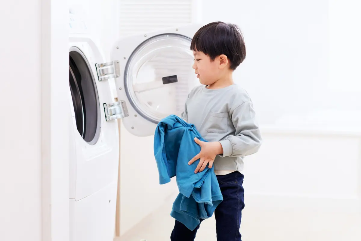 A little boy doing laundry, Is Professional Cleaning Actually Cheaper Than Doing It Yourself?